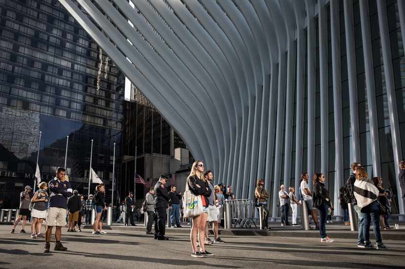 People gathered outside the World Trade Center Oculus for a moment of silence just before 9...