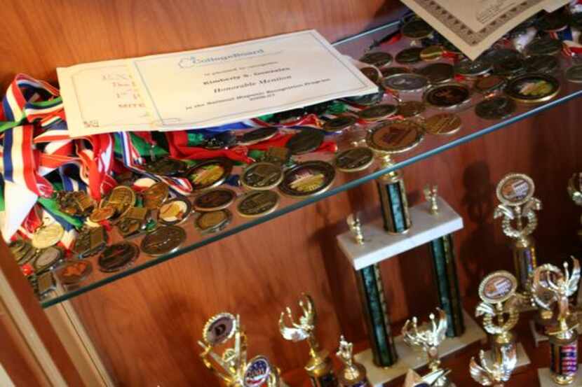 
A case full of trophies, medals and other academic awards stands in the Gonzales’ North...