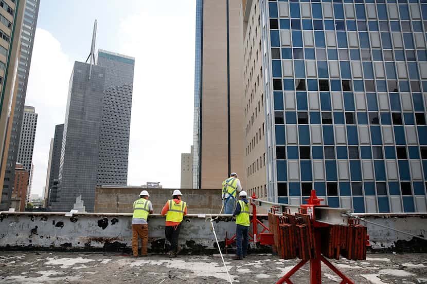 Construction workers begin work as renovation restarts at First National Bank Tower in...