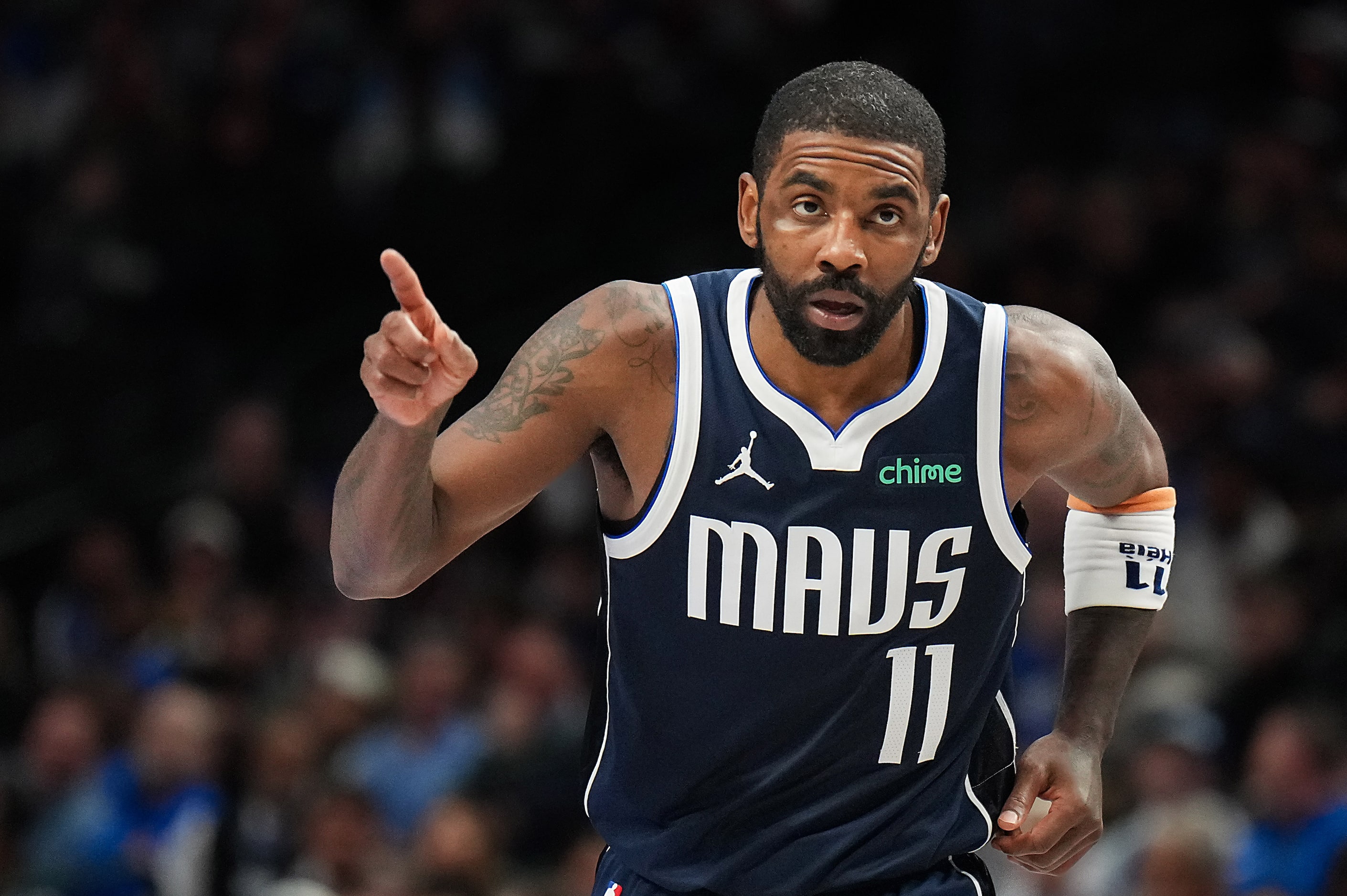 Dallas Mavericks guard Kyrie Irving points to the crowd as he leaves the game during the...