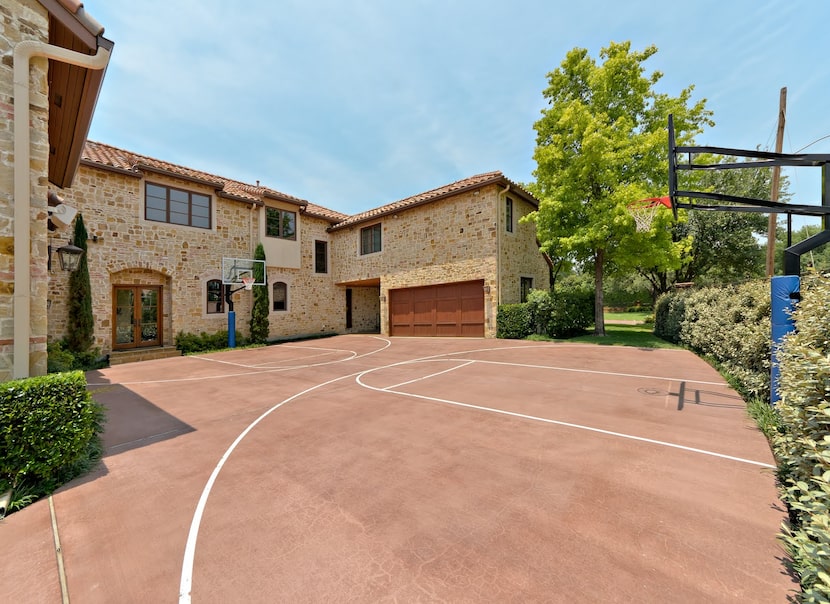 A driveway is turned into a basketball sport court.