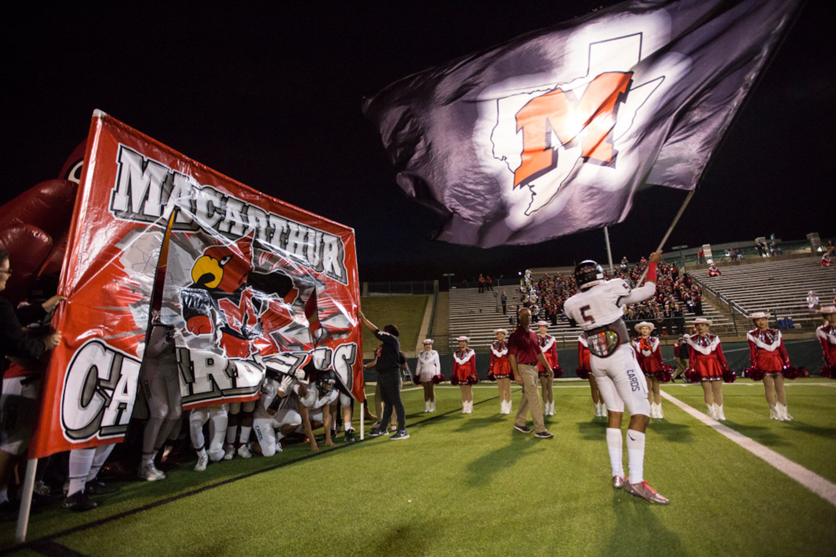 Irving MacArthur quarterback Brion Lopez (5) readies the Cardinals to take the field during...