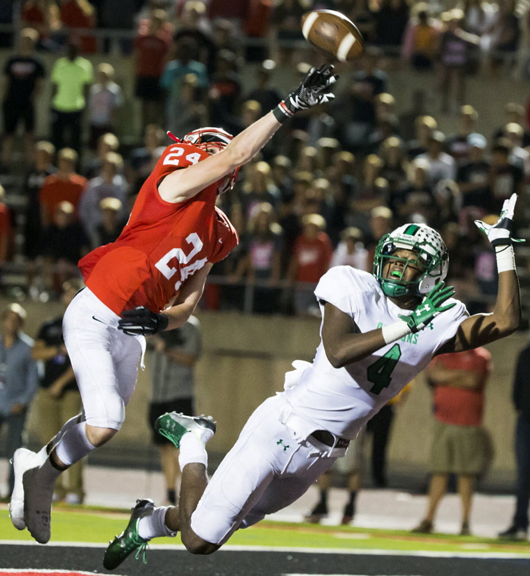 Coppell defensive backT.J. Mcdaniel (24) breaks up a pass intended for Southlake Carroll's...