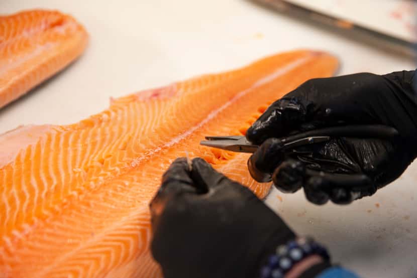 Rex's Seafood owner Beau Bellomy prepares a fish at Rex's Seafood in Dallas.