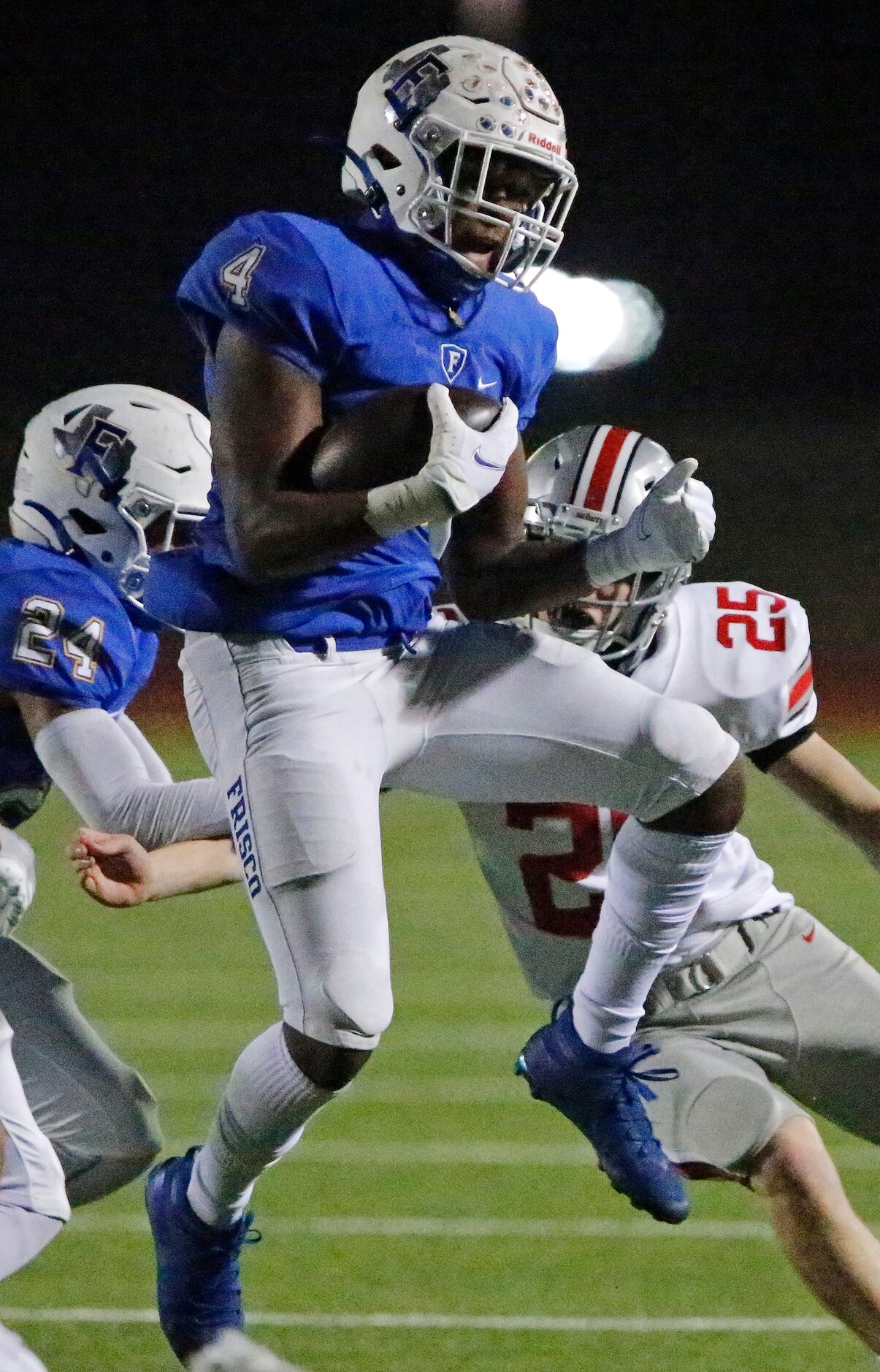 Frisco High School wide receiver Chase Lowery (4) returns a kickoff and is tackled by...