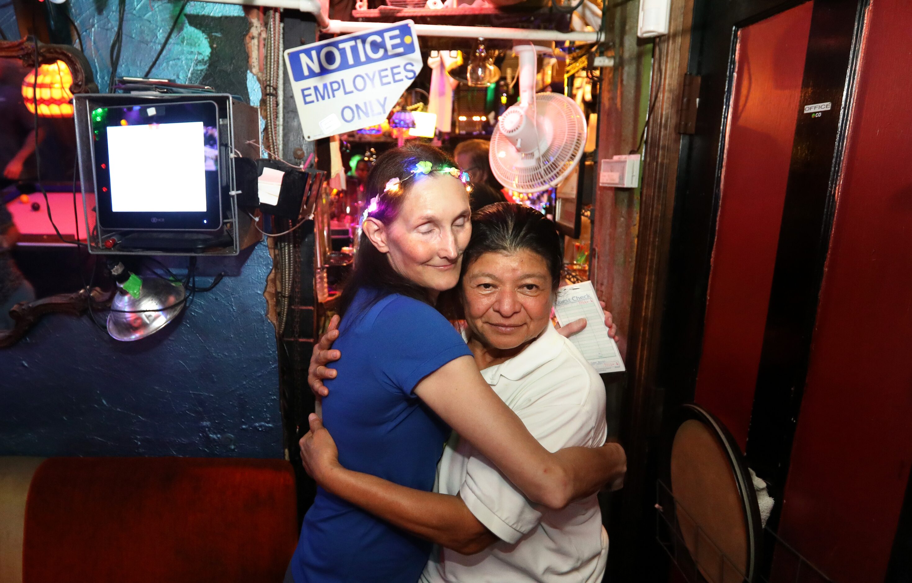 Michelle Honea, left, and Maria Alicia Gomez hug during their last evening at the Grapevine...