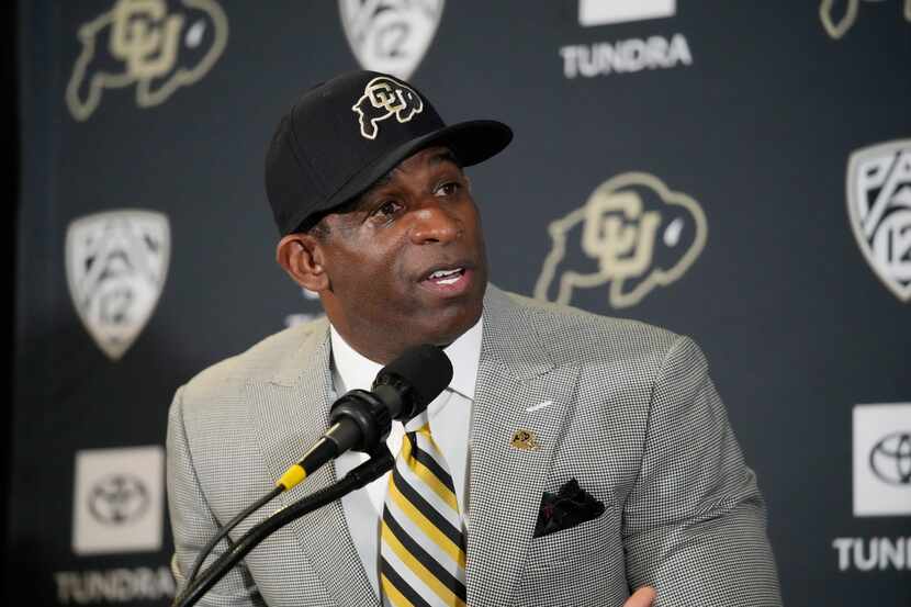 Deion Sanders speaks after being introduced as the new head football coach at the University...
