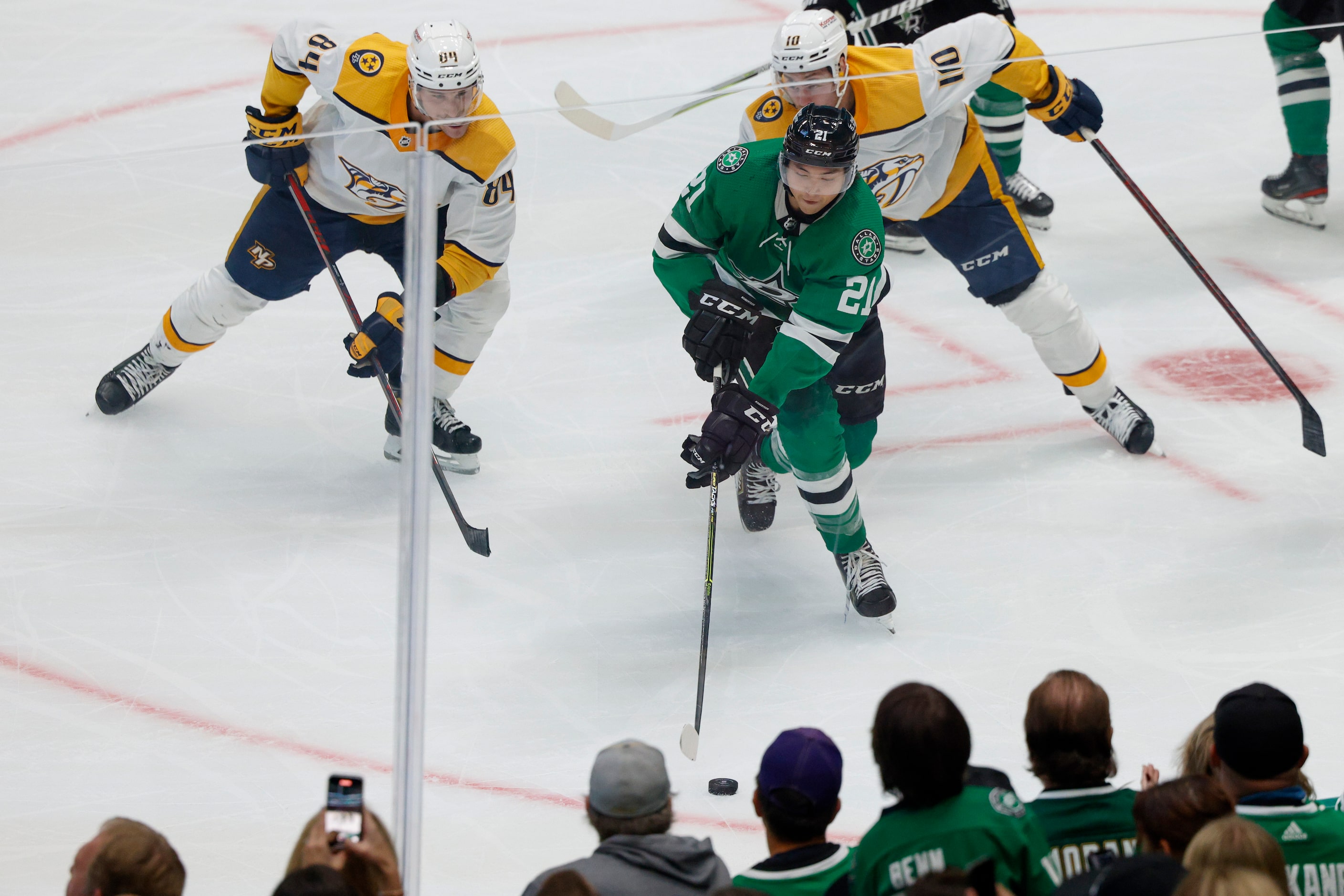 Dallas Stars left wing Jason Robertson (21) chases after a loose puck ahead of Nashville...