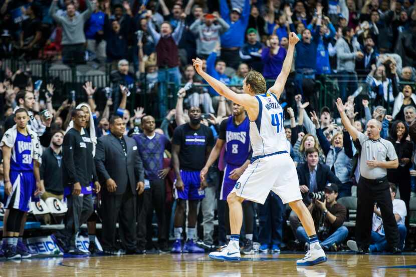 Dallas Mavericks forward Dirk Nowitzki (41) celebrates after Dallas Mavericks guard Deron...