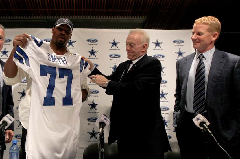 (From left) Stephen Jones, Dallas Cowboys executive vice president, looks on as new draftee...