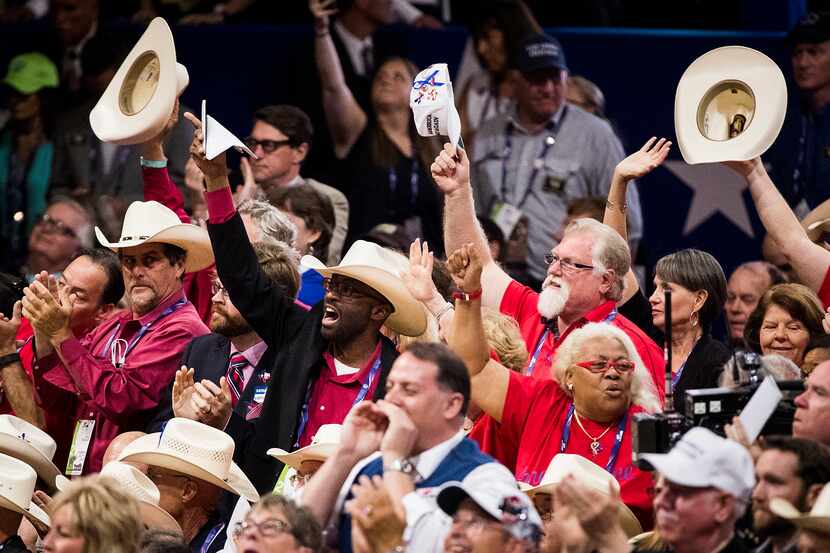 Texas delegates celebrate after the California delegation put Donald Trump over the top for...