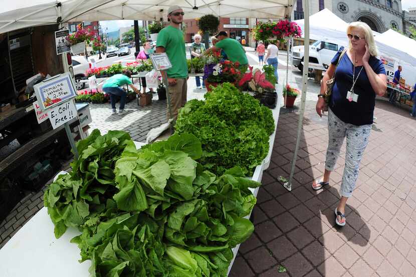 People walk by E. Coli free Romaine Lettuce at O'Malia's Farm Stand on the opening day of...