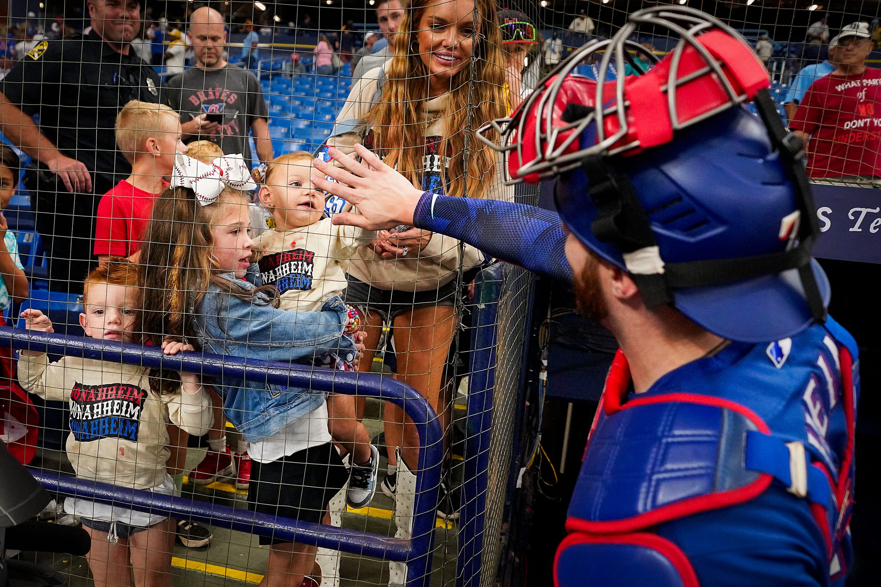 Texas Rangers catcher Jonah Heim celebrates with his family after a victory over the Tampa...