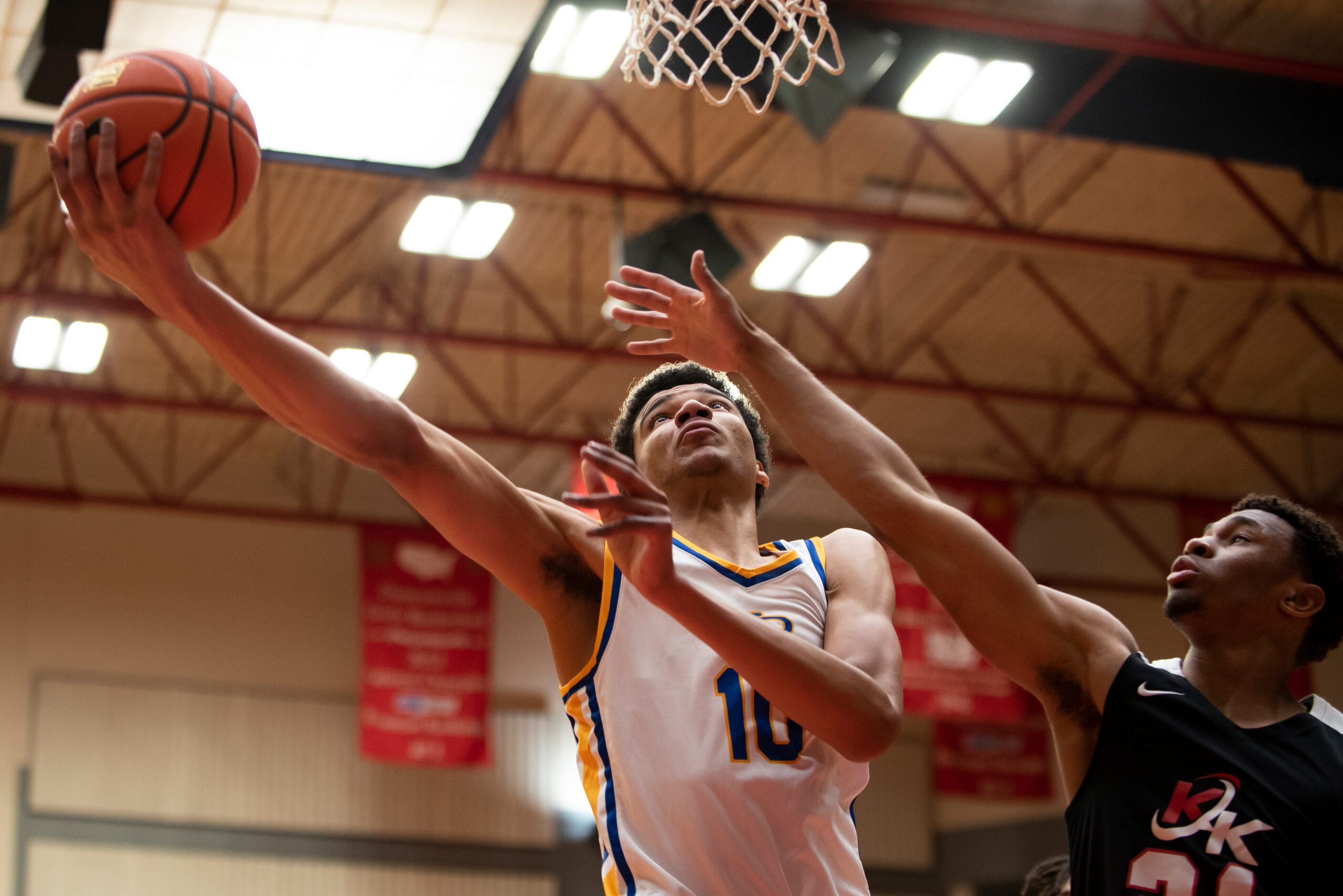 North Little Rock senior Kelel Ware (10) goes up for a layup around Kimball senior Landen...