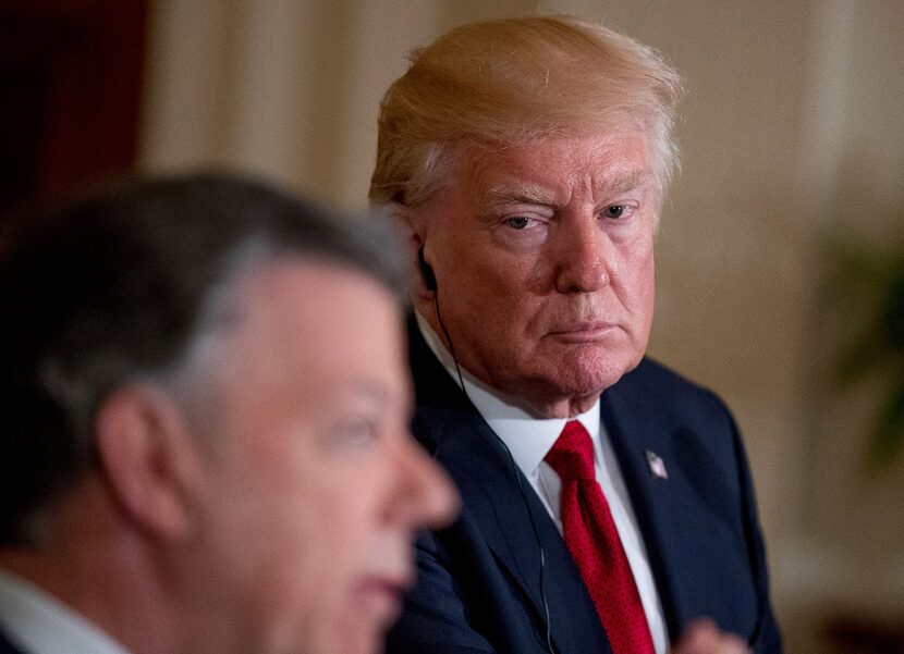 President Donald Trump, right, listens as Colombian President Juan Manuel Santos, left,...