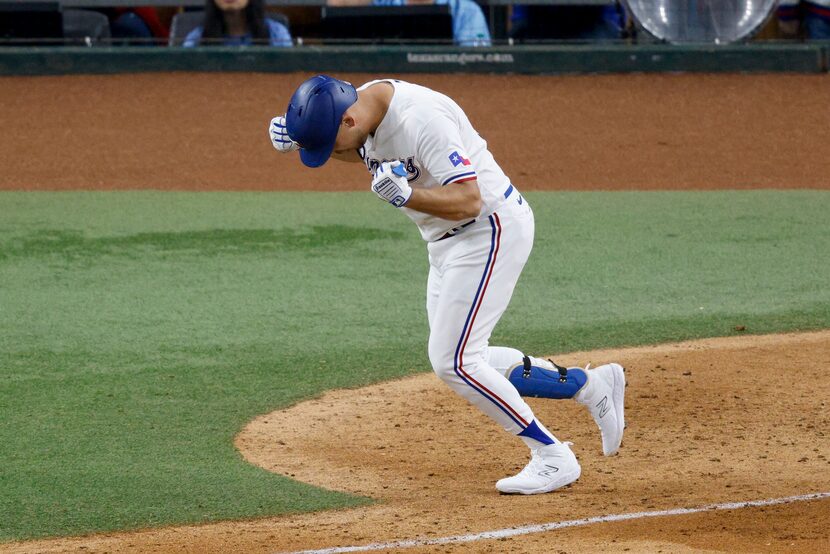 Texas Rangers first baseman Nathaniel Lowe (30) reacts after hitting a home run during the...