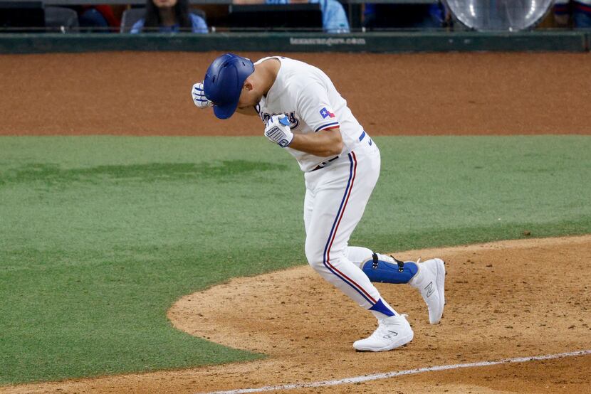 Nate Lowe of the Texas Rangers reacts after hitting the game winning