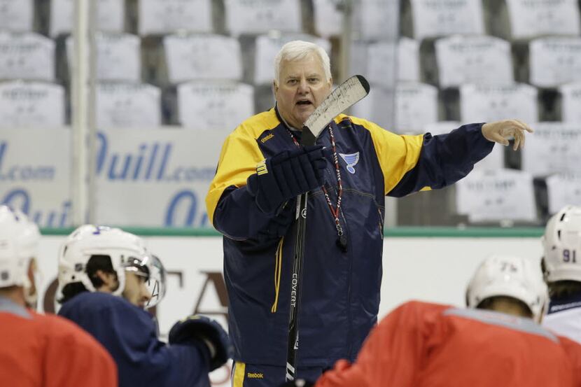 St. Louis Blues head coach Ken Hitchcock speaks to players during practice for Game 2 of the...