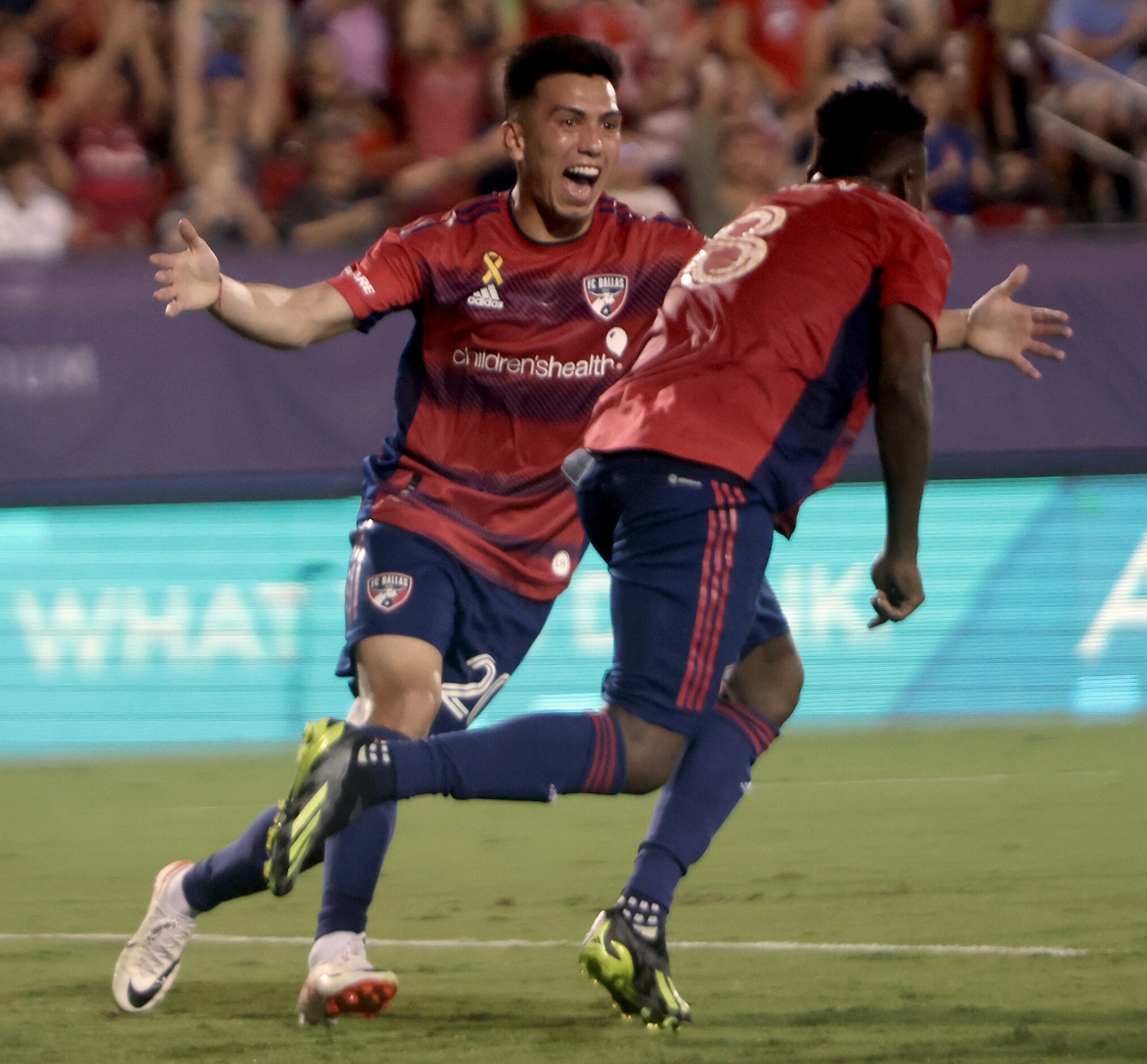 FC Dallas midfielder Alan Obrian (20), left, celebrates after attacker Jader Obrian (8)...