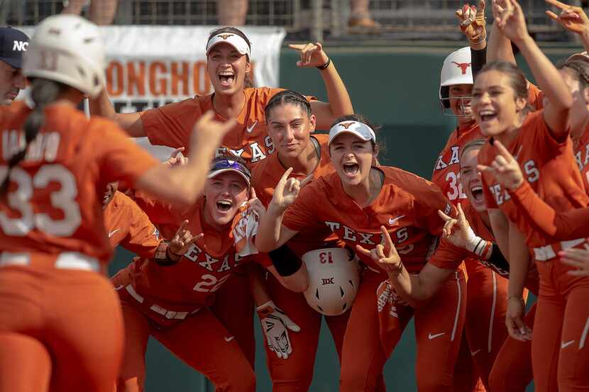 Texas players celebrate a home run hit by catcher Mary Iakopo (33) against Sam Houston State...