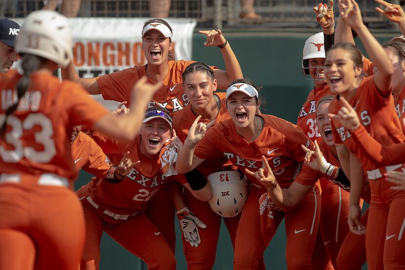 Texas players celebrate a home run hit by catcher Mary Iakopo (33) against Sam Houston State...