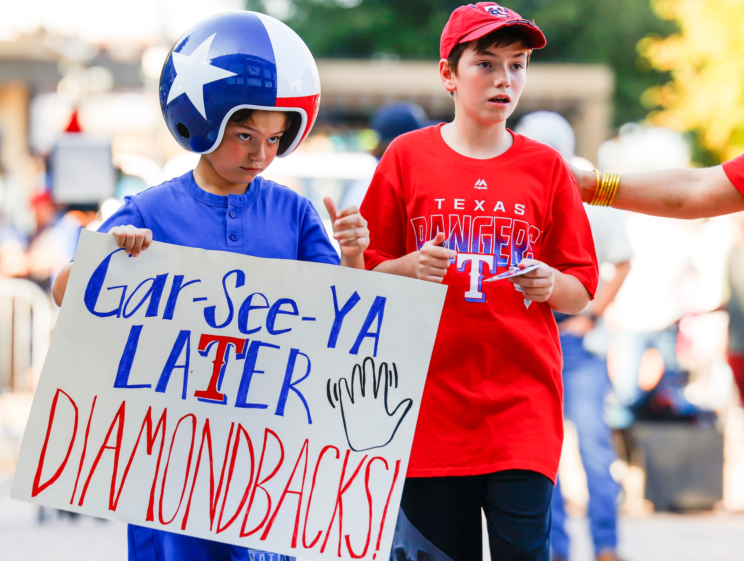 Grant Hall, 9, (left) and his brother, Paxton, 12, make their way into the Globe Life Field...