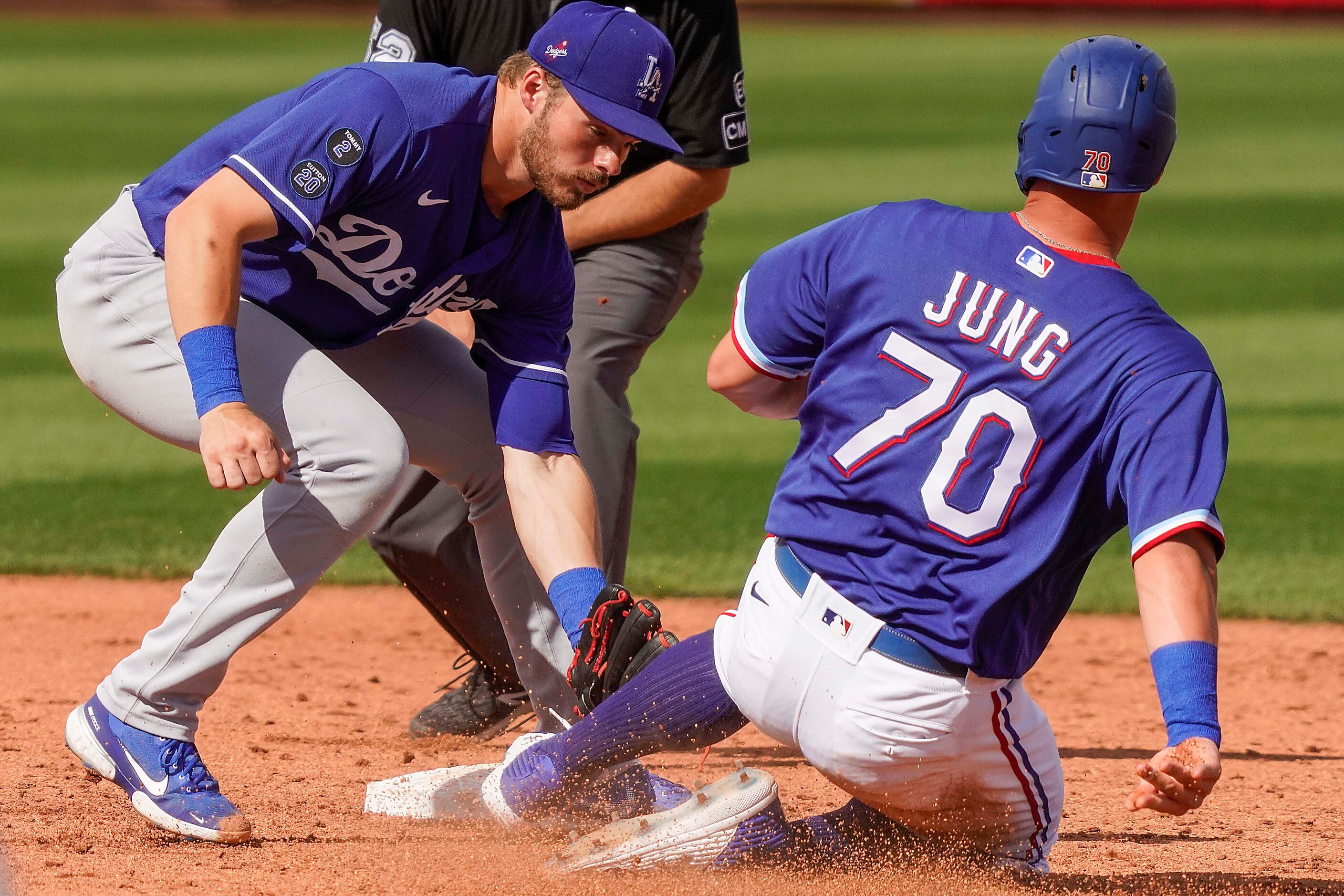 Texas Rangers infielder Josh Jung is caught stealing as Los Angeles Dodgers second baseman...