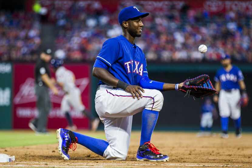 Texas Rangers first baseman Jurickson Profar (19) tosses and catches the ball after an out...