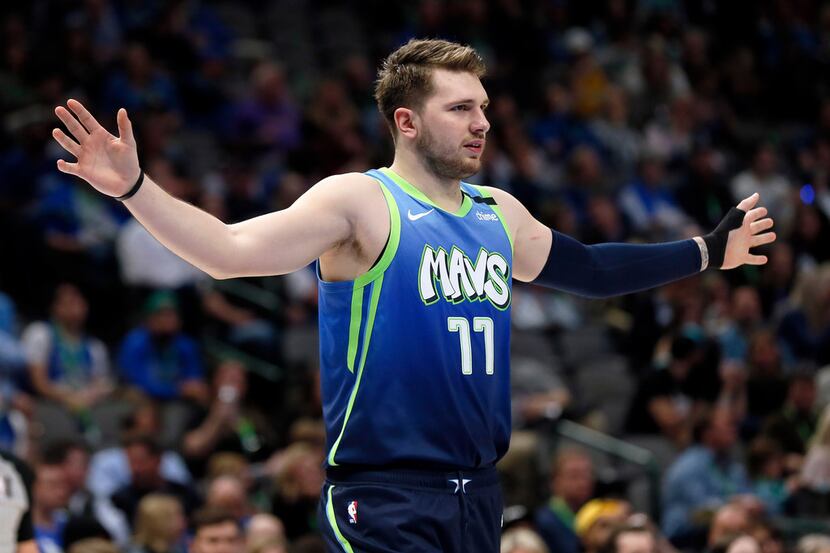 Dallas Mavericks guard Luka Doncic reacts to a foul call during the second half of an NBA...