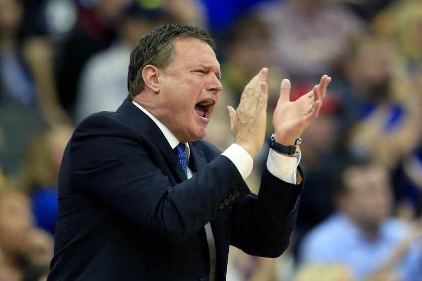 FILE - In this Thursday, March 23, 2017, file photo, Kansas coach Bill Self applauds his...