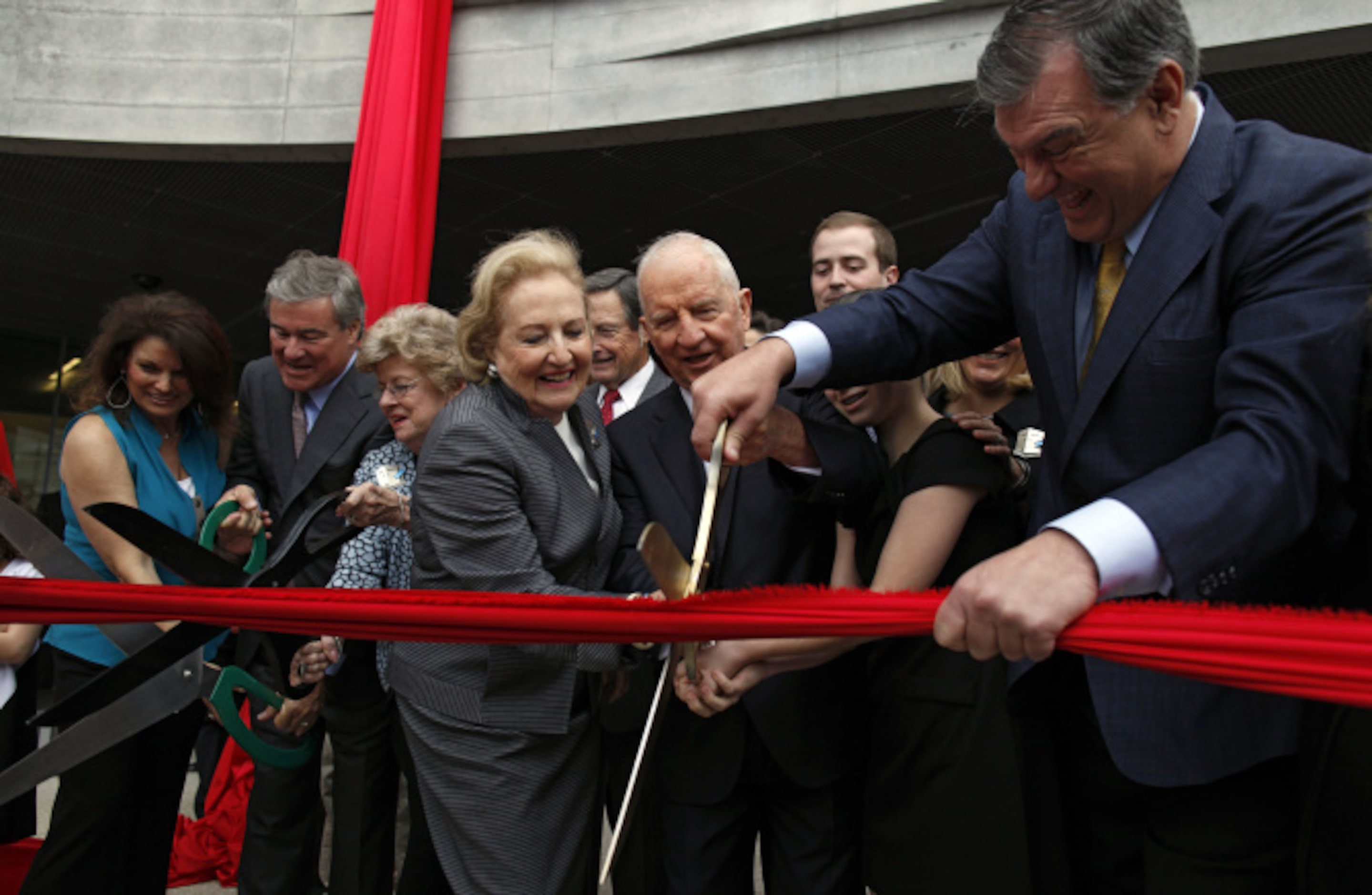 Margot Perot, Ross Perot and Dallas Mayor Mike Rawlings cut the ribbon during the opening of...