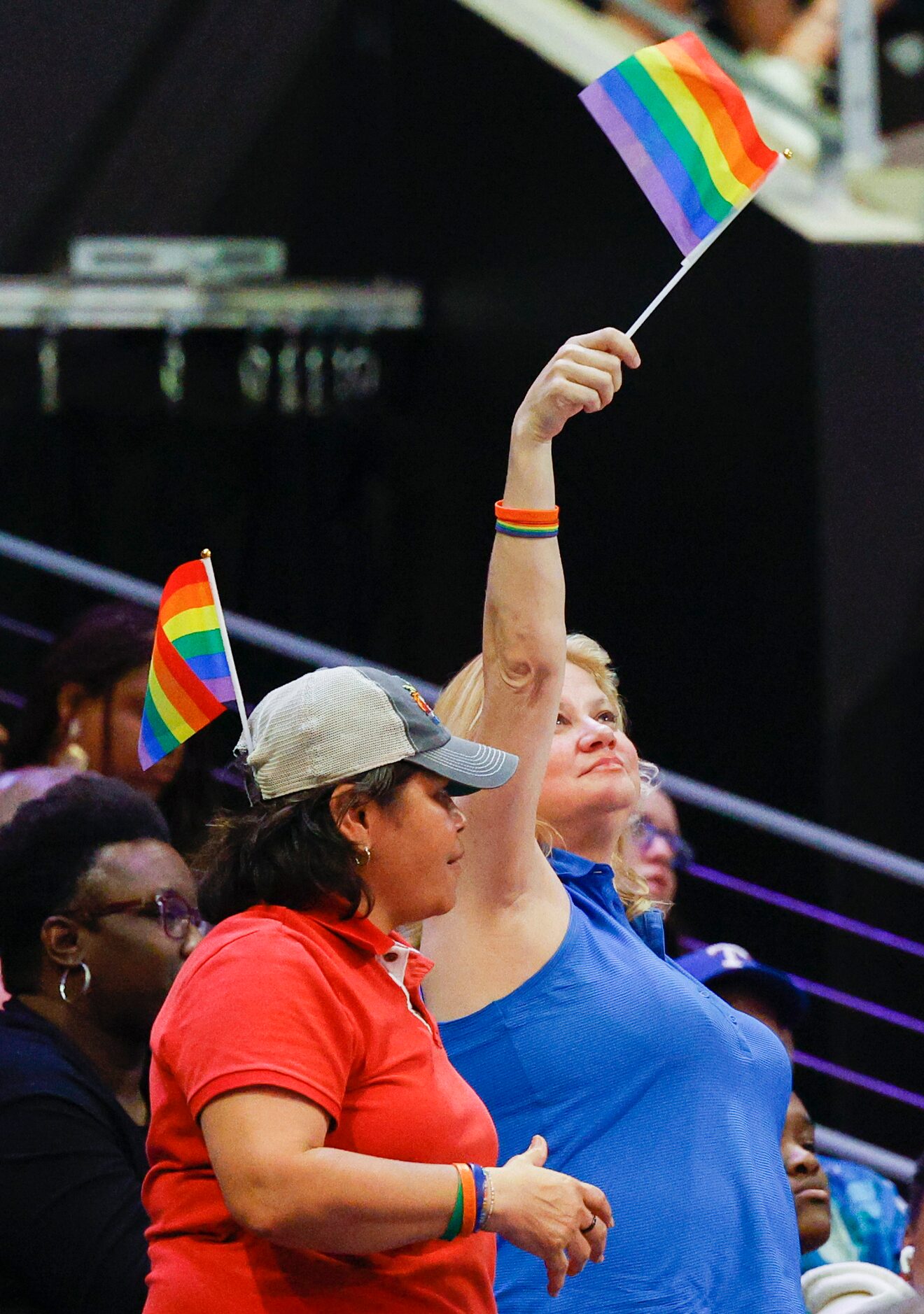 Fans wave pride flags during the second half of a game between the Dallas Wings and the...