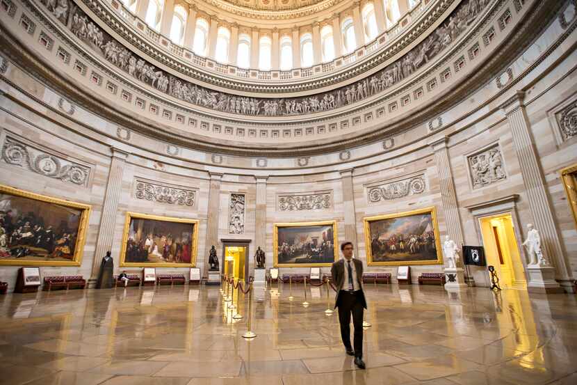 Normally packed with visitors and tourists, the U.S. Capitol Rotunda is empty as the...