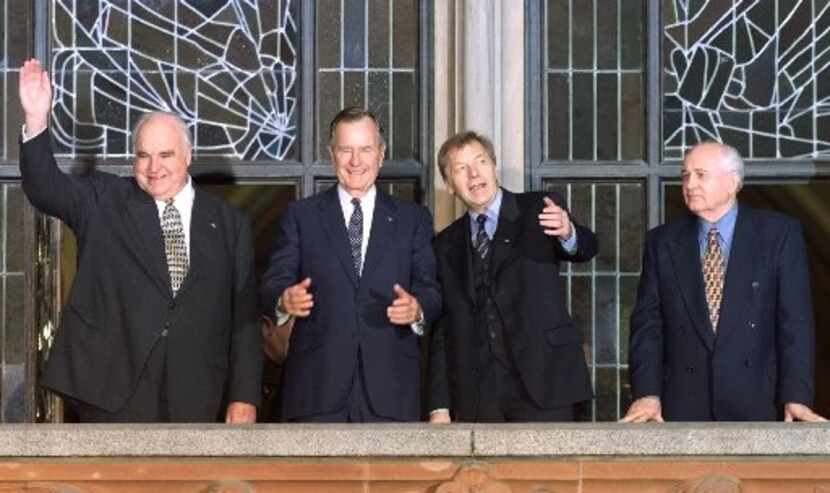 Former U.S. President George Bush is flanked by former German Chancellor Helmut Kohl, left,...