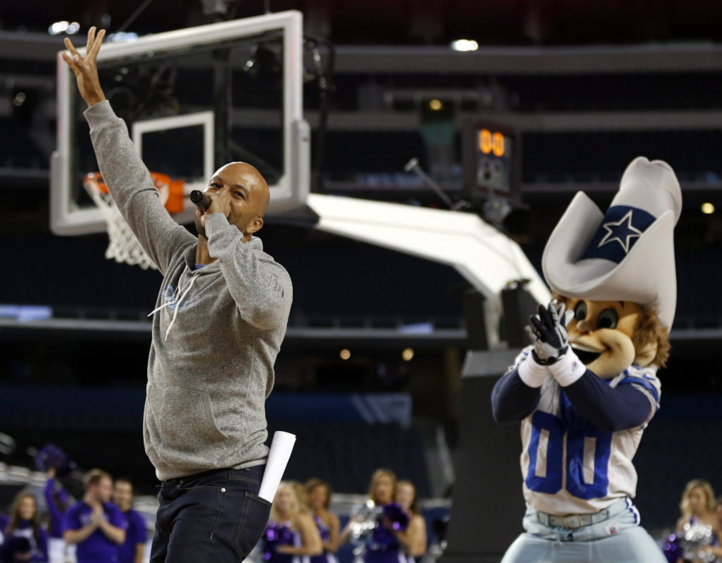 Common makes his way on the court after hugging Dallas Cowboys Rowdy during the Reese's...