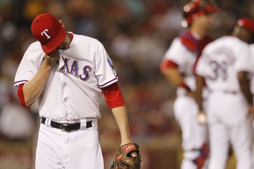 Texas Rangers relief pitcher Tanner Scheppers (52) leaves the mound after hitting two...
