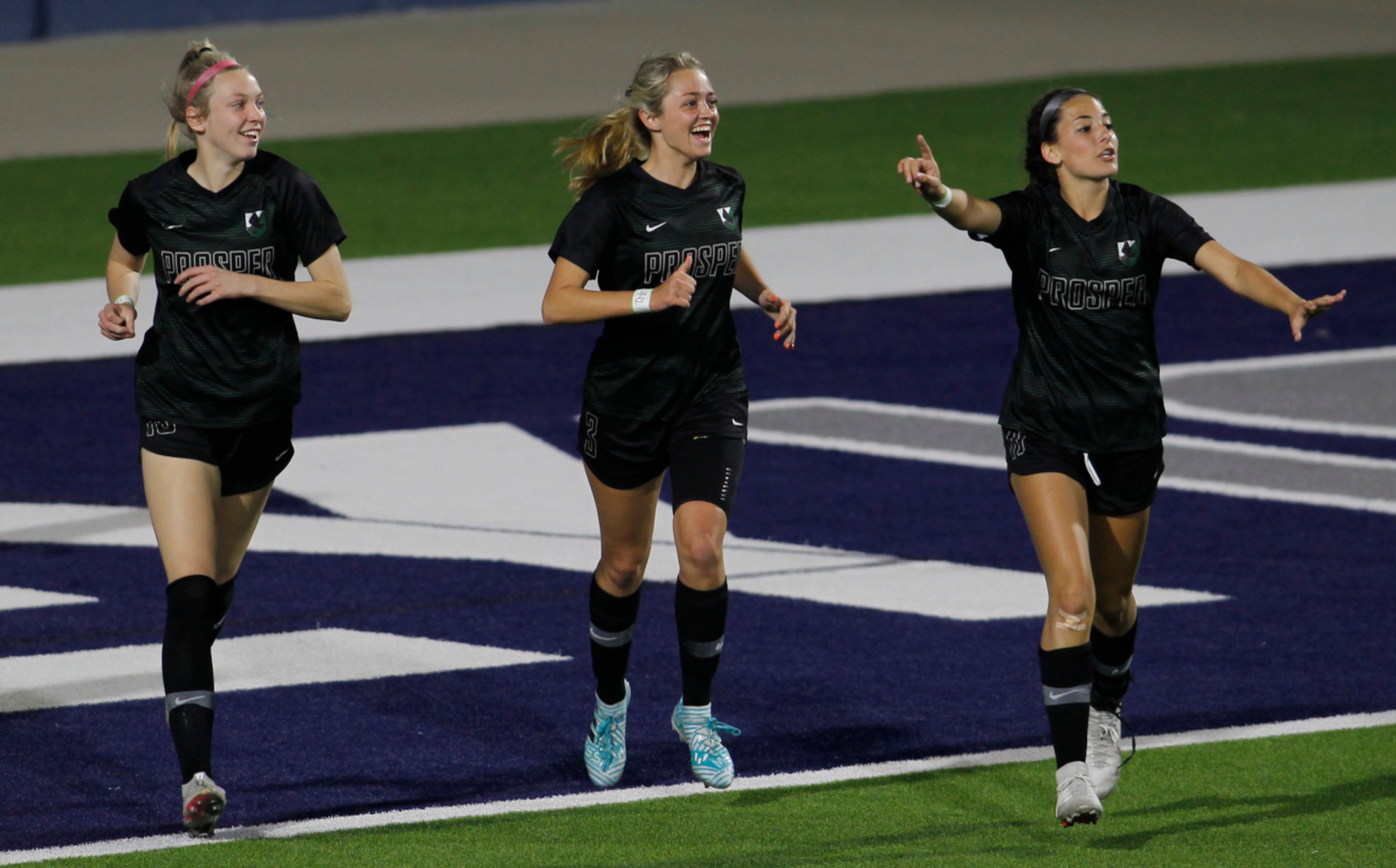 Framed by teammates Hadley Murrell (10), left, and Emma Yolinsky (11), right, Prosper...