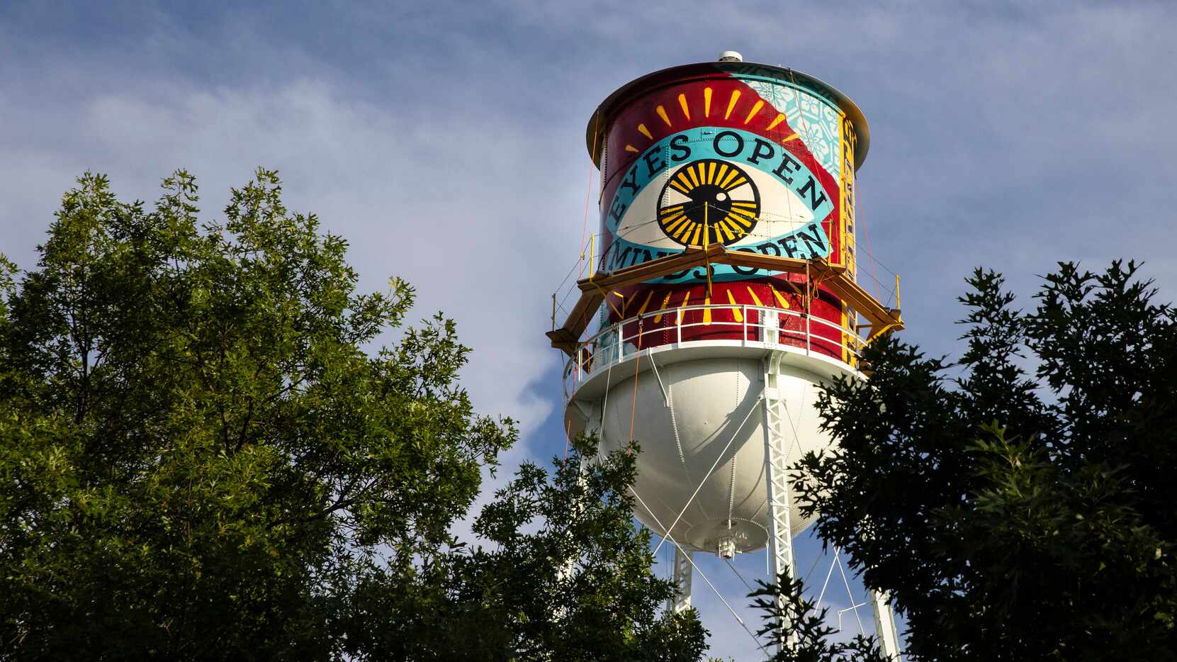A new mural by Shepard Fairey appears on the side of a water tower by the Continental Gin...