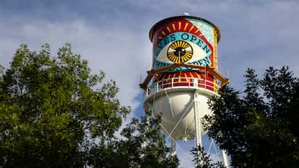 A new mural by Shepard Fairey appears on the side of a water tower by the Continental Gin...