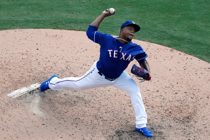 Texas Rangers relief pitcher Edinson Volquez throws to the Seattle Mariners in the seventh...