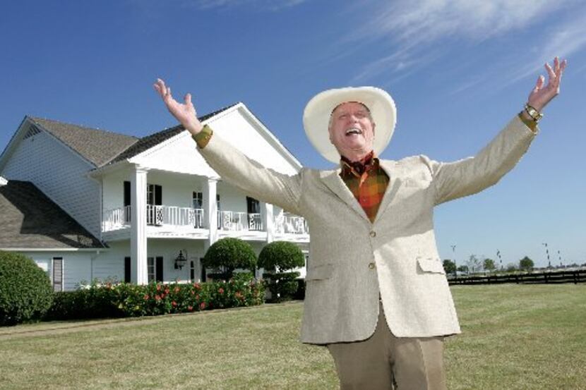 ORG XMIT: *S0424523461* Actor Larry Hagman poses in front of the  Southfork Ranch mansion...