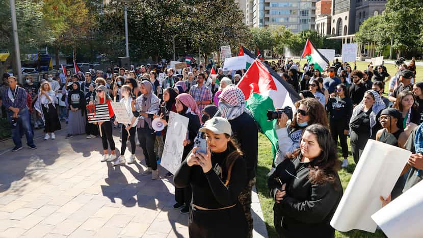 People gather during a Palestinian protest to end the siege in Gaza and media complicity at...
