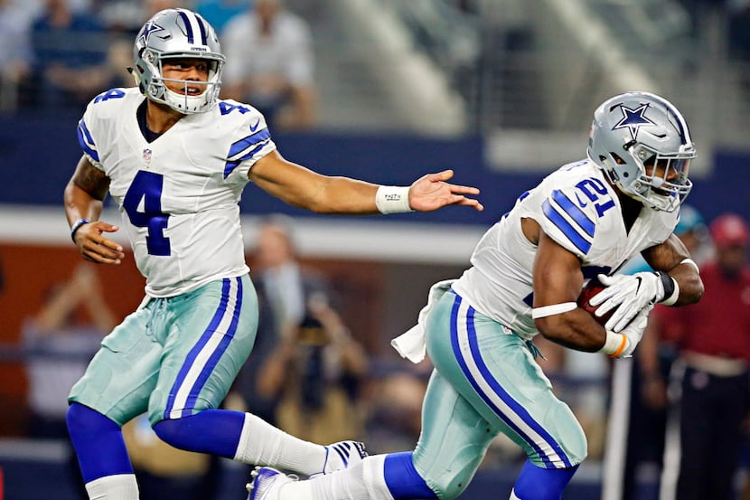 Dallas Cowboys quarterback Dak Prescott (4) hands off to running back Ezekiel Elliott during...
