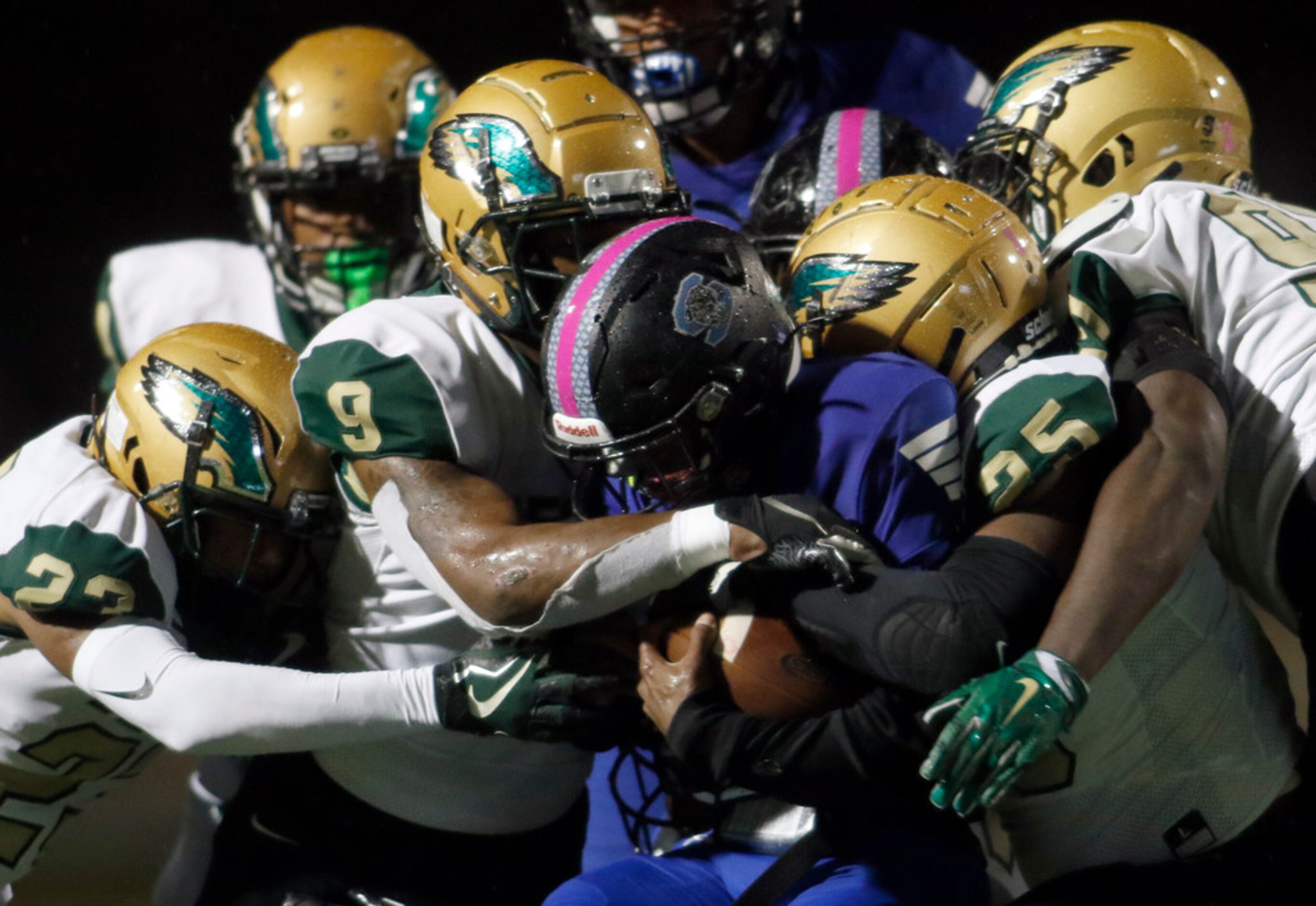 Mansfield Summit running back Jayden Lott (6) is swarmed by DeSoto defenders Timmie Jennings...