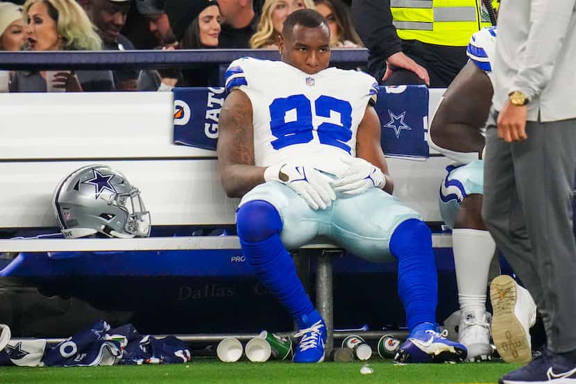 Dallas Cowboys defensive end Dorance Armstrong (92) looks on from the bench during the...