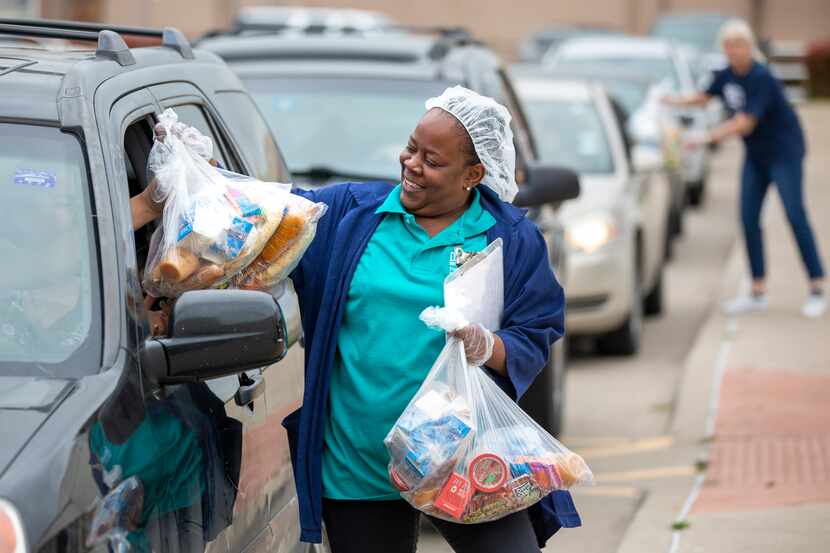 Food service supervisor Latoncia Anderson distributes meals.