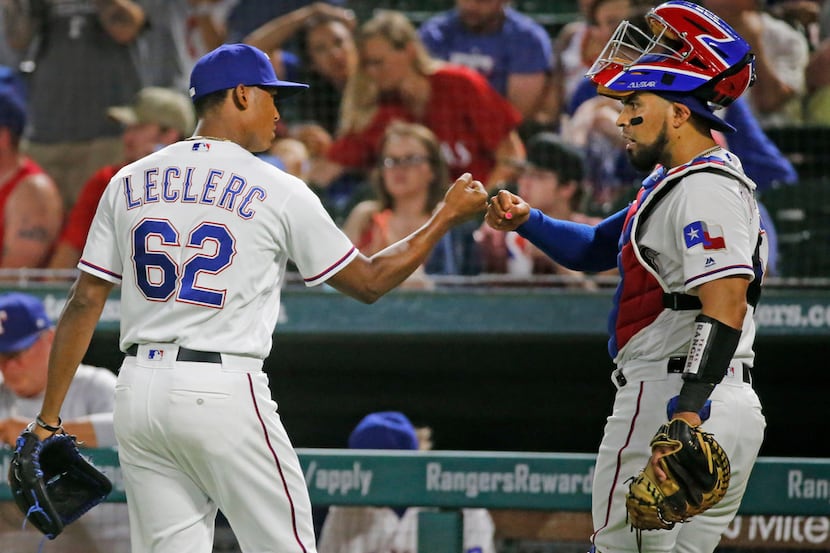 Texas Rangers relief pitcher Jose Leclerc (62) is congratulated by catcher Robinson Chirinos...