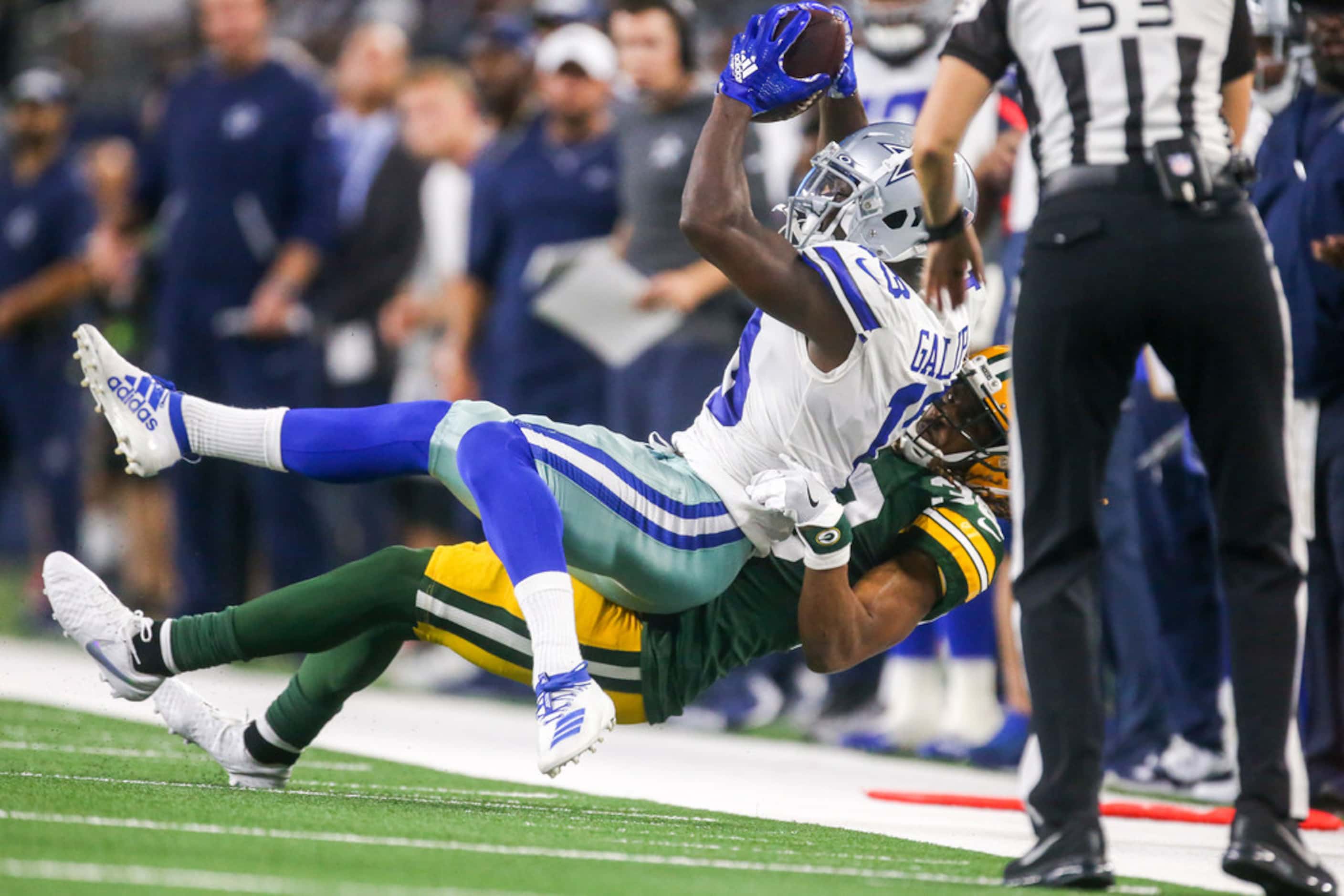 Dallas Cowboys wide receiver Michael Gallup (13) gets thrown to the ground by Green Bay...