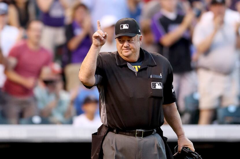 DENVER, CO - JUNE 20:  Home plate umpire Joe West #22  acknowledges the crowd after being...