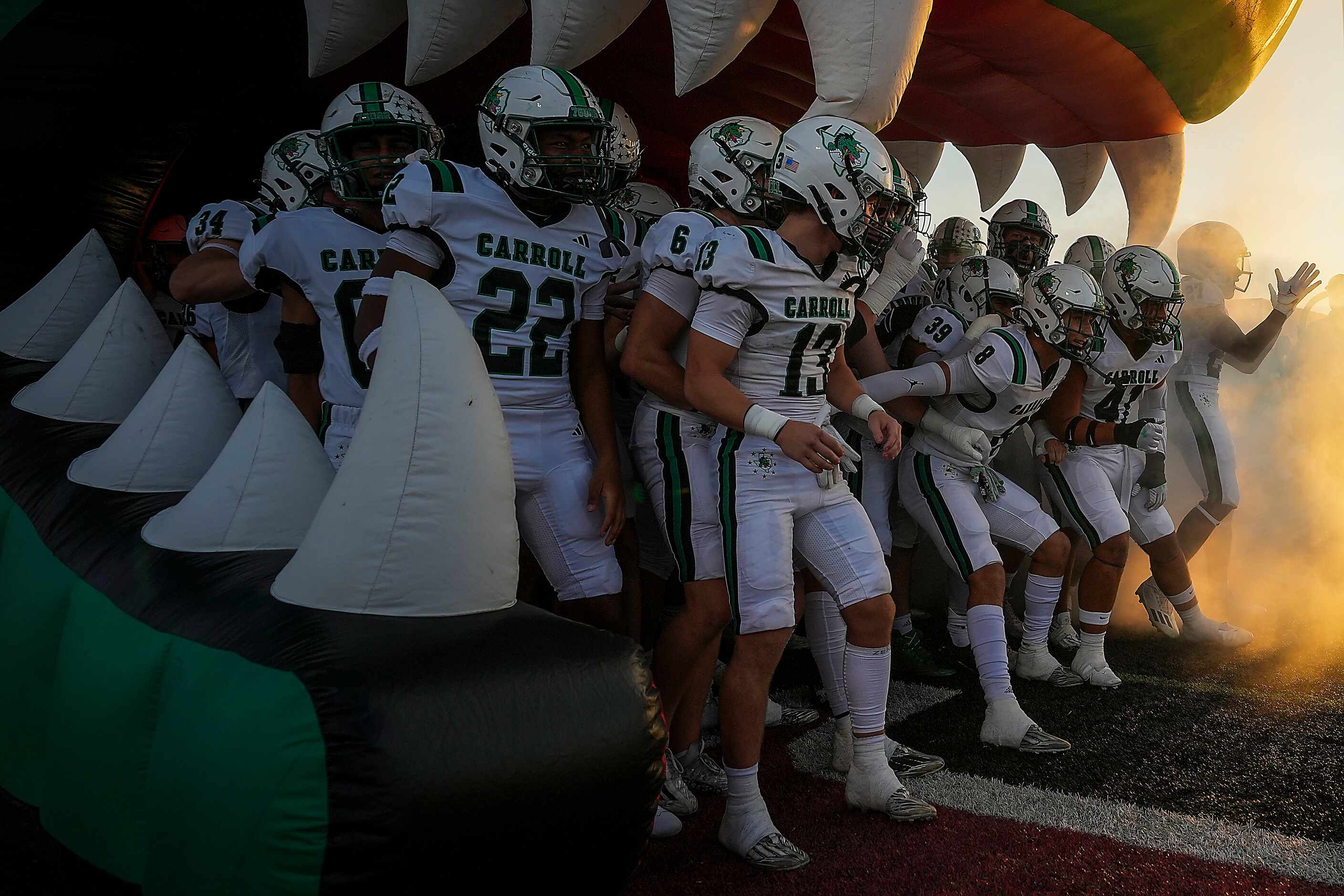 Southlake Carroll players prepare to take the field for a high school football game against...